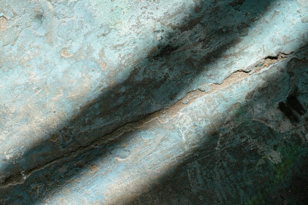 Light shining through a crack near a window, symbolizing hope and solutions found for career pressure via Qi Men Dun Jia environmental adjustment.